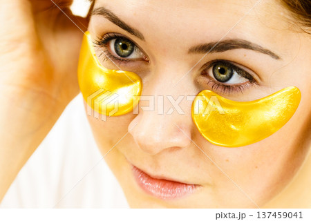 Woman with gold patches under eyes 137459041