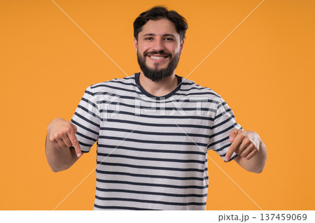 Mature Bearded Man Points Both Index Fingers Downward To Indicate Area Below Mature Bearded Man Points Both Index Fingers Downward To Indicate Area Below 137459069