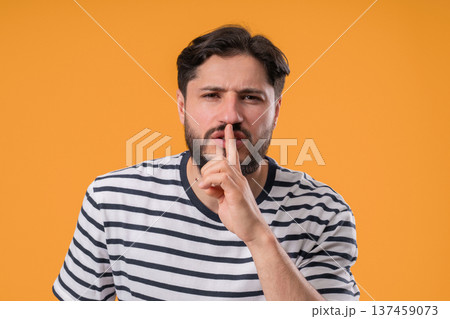 Bearded man with gesture of shhh, secret, silence, conspiracy, quiet, rumor concept. Smiling guy 137459073
