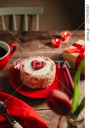 Valentine's Day background. Cake with red heart, candles, gift box and cup of coffee on table. Love celebration 137459087