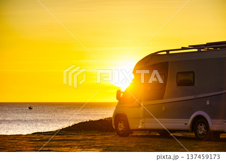 Camper car on beach at sunrise 137459173