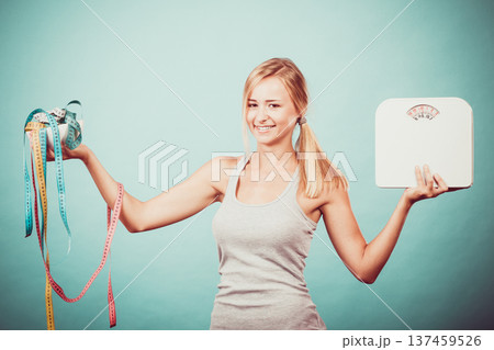 Girl with scales measuring tapes. Weight loss. Girl with scales measuring tapes. Weight loss. 137459526