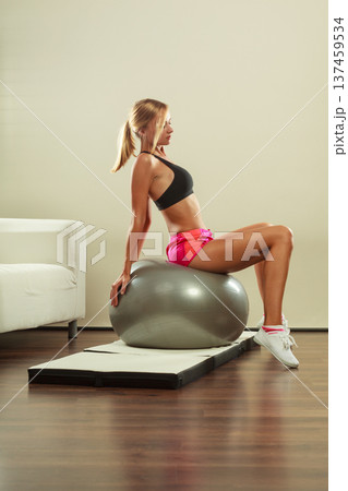 woman doing fitness exercises with fit ball woman doing fitness exercises with fit ball 137459534