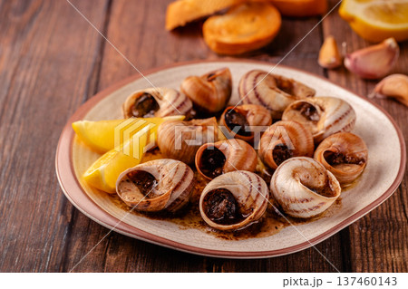 snails with butter on a plate snails with butter on a plate 137460143
