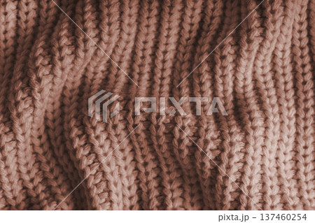 Crumpled brown knitted fabric texture with folds, wrinkles and soft waves, wool background Crumpled brown knitted fabric texture with folds, wrinkles and soft waves, wool background 137460254