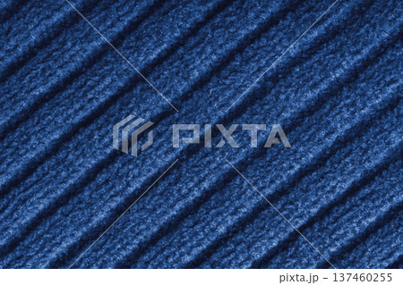 Blue colored knitted fabric, knitwear texture with diagonal soft ribbed pattern background Blue colored knitted fabric, knitwear texture with diagonal soft ribbed pattern background 137460255
