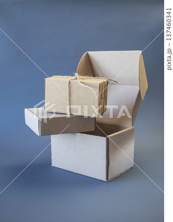 Cardboard boxes and packing twine, delivery concept. Stacking of postal cardboard boxes and packing twine. Cardboard boxes and packing twine, delivery concept. Stacking of postal cardboard boxes and packing twine. 137460341
