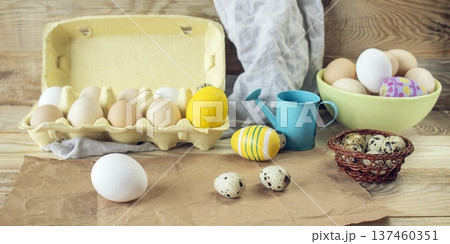 Easter, preparation for the holiday. Various colored and fresh chicken and quail eggs on a rustic wooden table. Easter, preparation for the holiday. Various colored and fresh chicken and quail eggs on a rustic wooden table. 137460351