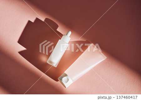 Skincare dropper bottle and tube with shadows Skincare dropper bottle and tube with shadows 137460417