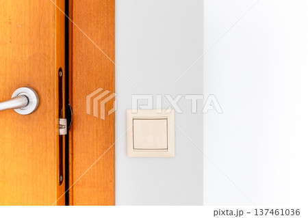 wooden door and electric switch close up 137461036