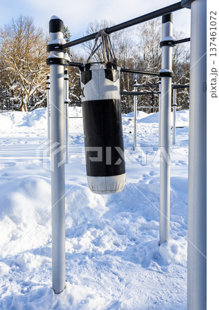 punching bag on outdoor sport ground in snowy park 137461072