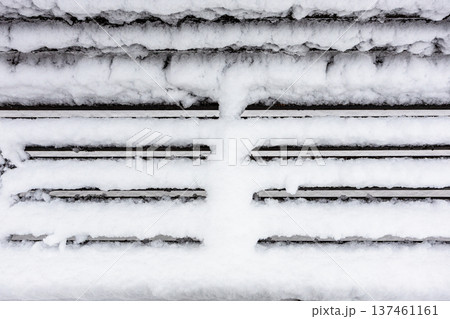 frozen surface of snow-covered wooden bench 137461161