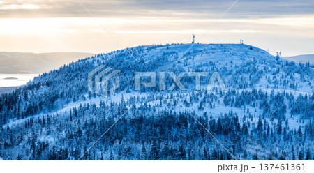snowy hill near Kandalaksha town in winter dusk 137461361