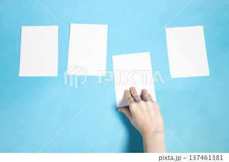 top view of hand takes sheet of white papers top view of hand takes sheet of white papers 137461381