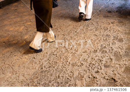 people walk on dirty melting snow on street tiles people walk on dirty melting snow on street tiles 137461506