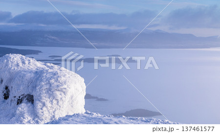 frozen rock and view of Kandalaksha bay in haze frozen rock and view of Kandalaksha bay in haze 137461577