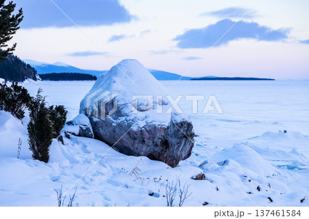 snowy memorial stone on coast of Kandalaksha Bay snowy memorial stone on coast of Kandalaksha Bay 137461584