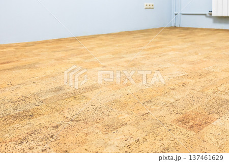 freshly laid brown cork tile flooring in room 137461629