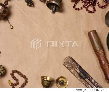 Religious objects for prayer and meditation, with a sheet of brown paper in the middle for writing. 137461740
