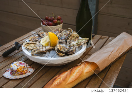 Fresh Raw Oysters with Citron, Baguette, Butter, and Cider 137462424
