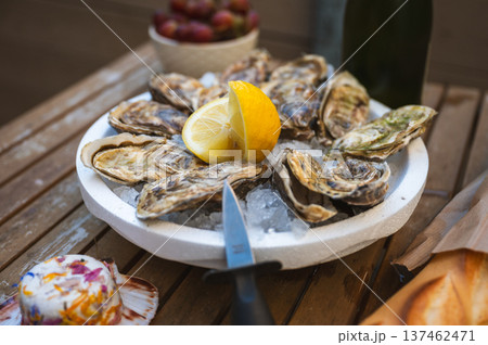 Fresh Raw Oysters with Citron, Baguette, Butter, and Cider 137462471