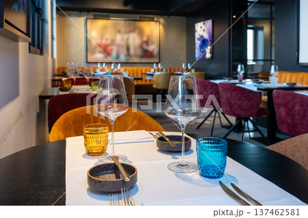 Intimate and charming dining environment featuring candle glow and plush velvet seating for special occasions 137462581