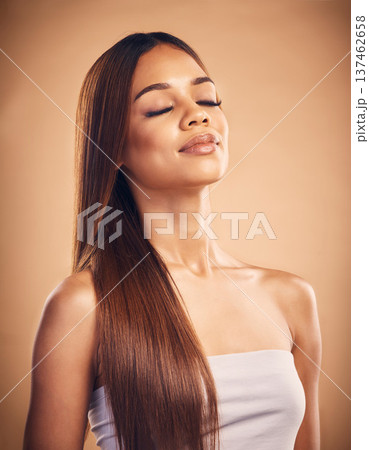 Face, hair and shampoo with a natural woman in studio on a brown background for keratin treatment. Beauty, glow and confident with a happy young model at the salon for growth or aesthetic haircare Face, hair and shampoo with a natural woman in studio on a brown background for keratin treatment. Beauty, glow and confident with a happy young model at the salon for growth or aesthetic haircare 137462658