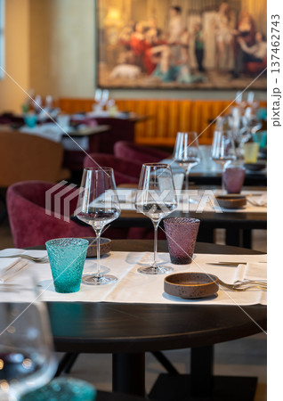 Refined glasses with warm reflections. Classy arrangement of wine goblets under soft ambient lighting 137462743