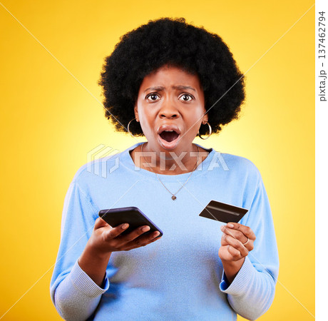 Shock, credit card and woman portrait with phone scam and fraud from problem in studio. Stress, mobile and confused from phishing, hacking and ecommerce spam with anxiety and yellow background Shock, credit card and woman portrait with phone scam and fraud from problem in studio. Stress, mobile and confused from phishing, hacking and ecommerce spam with anxiety and yellow background 137462794