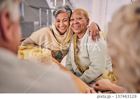Happy, smile and senior friends hugging at a birthday party, celebration or event at retirement home. Excited, bonding and elderly women embracing with love, care and happiness in a modern house. Happy, smile and senior friends hugging at a birthday party, celebration or event at retirement home. Excited, bonding and elderly women embracing with love, care and happiness in a modern house. 137463129