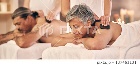 Relax, hot stone and zen with old couple in spa for vacation, luxury and beauty salon. Peace, wellness and holiday with senior woman and man in hotel villa for retirement, massage and body care 137463131