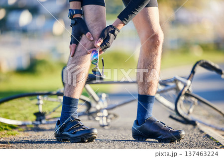 Man, cyclist and legs in knee injury, accident or pain after cycling exercise, fitness or outdoor workout on road. Closeup of male person or biker with sore bruise, inflammation or bicycle fall 137463224