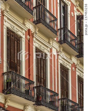 Ornate Red Historic Building Facade With Wooden Shutters and Wrought Iron Balconies in Mediterranean Malaga City Ornate Red Historic Building Facade With Wooden Shutters and Wrought Iron Balconies in Mediterranean Malaga City 137463238