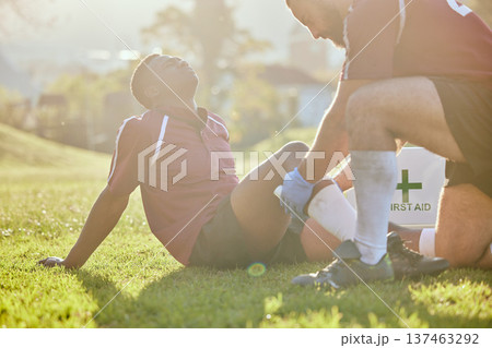 Football, medic and man with injury, field and pain with bruise, broken and inflammation with sunshine. Person, player and medical professional with equipment, fitness and match with emergency 137463292