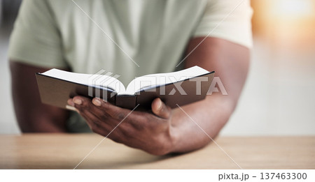 Bible, reading and hands with book and religion study at home for worship and spiritual support. Faith, christian knowledge and person with gratitude, scripture education and god guidance in a house 137463300