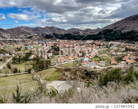 Idyllic mountain village featuring rocky valley and vibrant rooftops 137463542