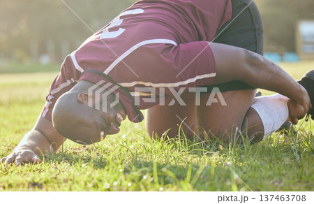 Sports, field injury and a black man during soccer with an emergency in fitness or training. Grass, pain and an African football player or athlete on the ground during a game with an accident Sports, field injury and a black man during soccer with an emergency in fitness or training. Grass, pain and an African football player or athlete on the ground during a game with an accident 137463708
