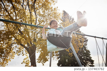 Smile, portrait or kid at playground on swing, growth or adolescent fun in winter holiday. Low angle, playful or Asian girl at park with flare, outdoor activity or child development on weekend break. Smile, portrait or kid at playground on swing, growth or adolescent fun in winter holiday. Low angle, playful or Asian girl at park with flare, outdoor activity or child development on weekend break. 137463782