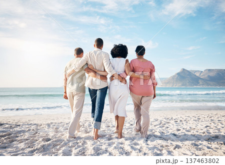 Back, hug and family at the beach for walking, travel or relax by the ocean on holiday. Together, care and parents with adult people at the sea during summer for a vacation, love or support in nature 137463802