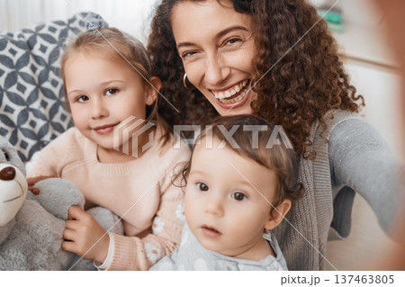 Selfie, smile and portrait of mother with her children bonding, relaxing and playing in the living room. Happy, love and young mom taking a picture with her kids for memory together in lounge at home 137463805