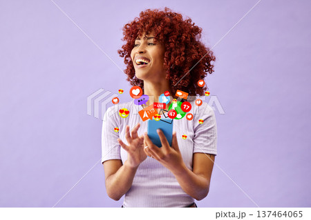 Phone, social media and emoji reaction with a black woman in studio on a purple background for communication. Mobile, app and notification with a happy young person using technology to like a post 137464065