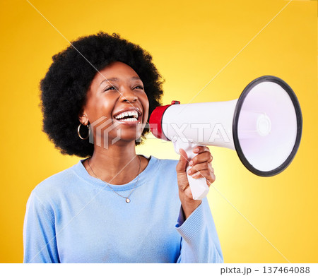 Happy black woman, megaphone and voice in promotion, advertising or marketing on a yellow studio background. African female person, smile or bullhorn for loudspeaker in sale announcement or alert Happy black woman, megaphone and voice in promotion, advertising or marketing on a yellow studio background. African female person, smile or bullhorn for loudspeaker in sale announcement or alert 137464088