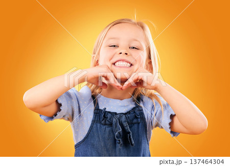 Happy, smile and portrait of child on orange background with happiness, joy and excited in studio. Fashion, childhood and hands on face of girl in fun or trendy outfit, young style and summer clothes Happy, smile and portrait of child on orange background with happiness, joy and excited in studio. Fashion, childhood and hands on face of girl in fun or trendy outfit, young style and summer clothes 137464304