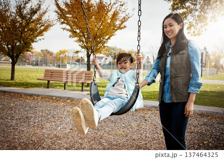 Asian family, autumn or swinging with mother and daughter outdoor together for bonding or having fun. Afternoon, fall or playful with happy girl child and single parent woman in park for break 137464325