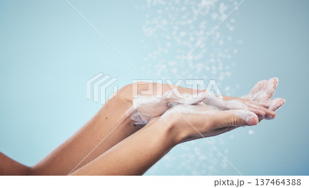 Cleaning, hands and woman with soap and water in studio, blue background and healthcare or skincare mockup. Model, closeup or washing skin for clean, hygiene and protection from bacteria or virus Cleaning, hands and woman with soap and water in studio, blue background and healthcare or skincare mockup. Model, closeup or washing skin for clean, hygiene and protection from bacteria or virus 137464388