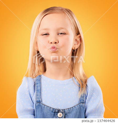 Happy, pout and portrait of girl on orange background with happiness, joy and excited in studio. Confidence, childhood and face of young, adorable and cute child with kiss emoji facial expression Happy, pout and portrait of girl on orange background with happiness, joy and excited in studio. Confidence, childhood and face of young, adorable and cute child with kiss emoji facial expression 137464426