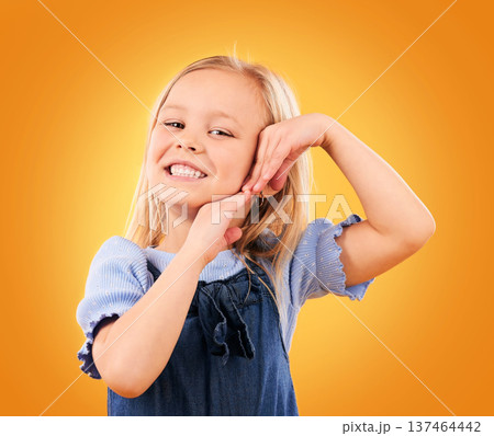 Smile, cute and portrait of a child on a studio background for youth, happiness or expression. Orange, young and face of a girl kid or female model with a gesture for adorable, positive or childhood 137464442