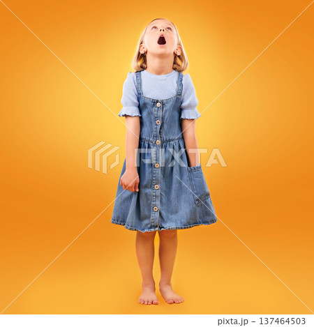Fashion, wow and girl child in studio for news, omg or coming soon promotion on orange background. Looking up, surprise and kid shocked by choice, sale or discount, announcement or prize giveaway Fashion, wow and girl child in studio for news, omg or coming soon promotion on orange background. Looking up, surprise and kid shocked by choice, sale or discount, announcement or prize giveaway 137464503