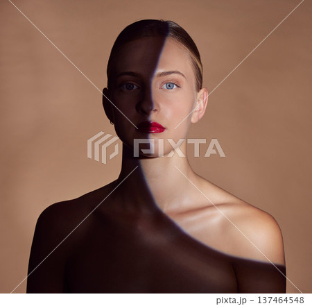 Spotlight, portrait or shadow for lipstick, beauty or creative aesthetic with light on studio background. Model, face or woman with dark side or art style for skincare, makeup or facial cosmetics Spotlight, portrait or shadow for lipstick, beauty or creative aesthetic with light on studio background. Model, face or woman with dark side or art style for skincare, makeup or facial cosmetics 137464548