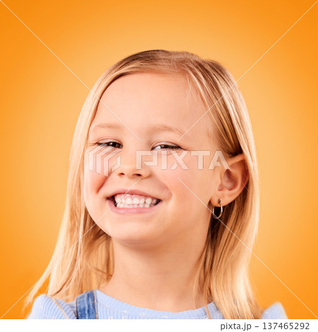 Happy, smile and portrait of girl on orange background with happiness, joy and excited in studio. Canada, childhood and face of young, confident and cute child relax with smile for positive attitude Happy, smile and portrait of girl on orange background with happiness, joy and excited in studio. Canada, childhood and face of young, confident and cute child relax with smile for positive attitude 137465292